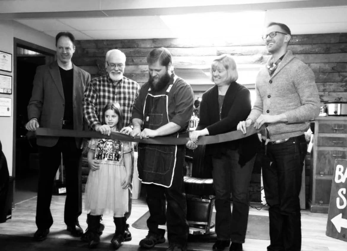 Ribbon cutting at the Front Porch Barber Shop's 10-year anniversary and Main Street relocation in February 2025